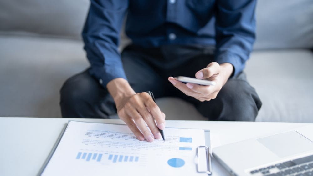 British Columbia Government Contractor Payment Terms Guide - Business owner reviewing financial documents.