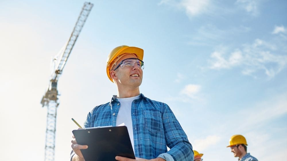 Manitoba Government Contractor Payment Terms Guide - government contractor with hard hat looking off into the distance.