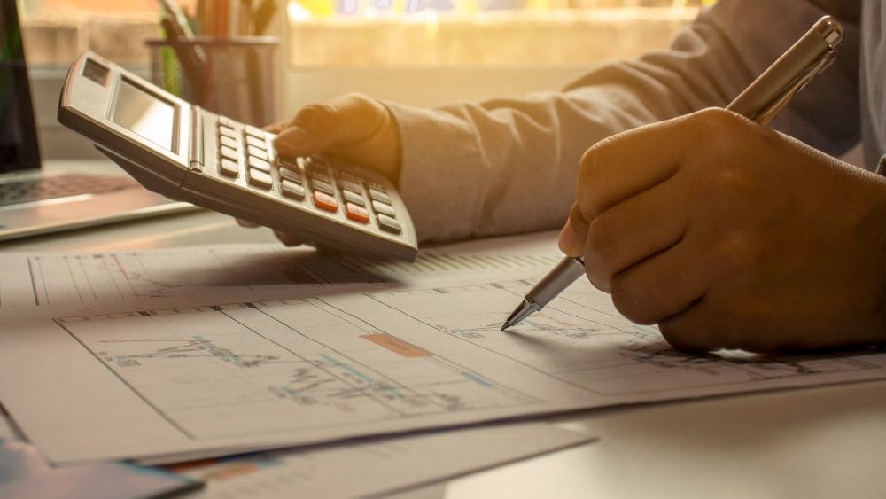 New Brunswick Government Contractor Payment Terms Guide - businessperson reviewing financial documents.