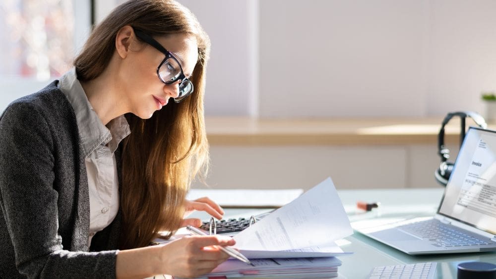 Ontario Government Contractor Payment Terms What to Expect - Woman reviewing invoices.