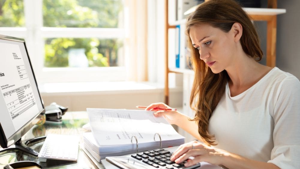 Prince Edward Island Government Contractor Payment Terms - Woman reviewing invoices.