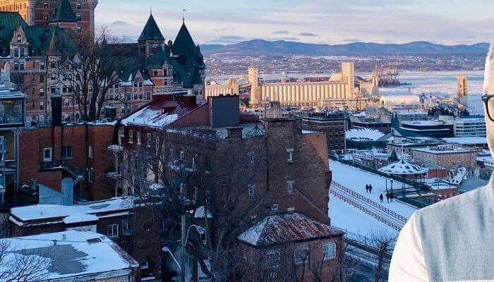 Quick Guide to Québec Government Contractor Payment Terms - business owner with Québec in background.